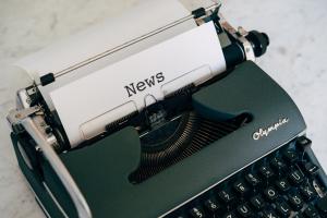 Typewriter with the word 'news' printed on the inserted paper.